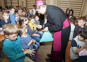 Bischof Stefan Oster gibt Geschenke an die Schulkinder